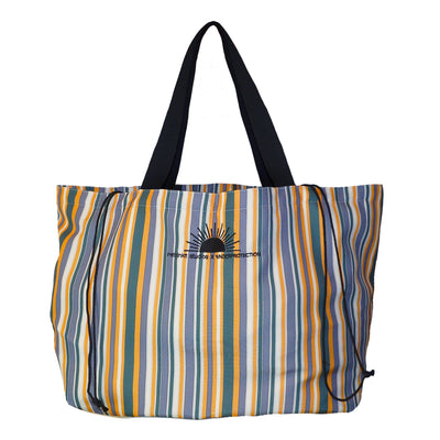 Multi colored beach tote bag with string tie and sun logo. Retro inspired tote bag with striped multi colored pattern.