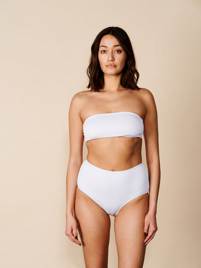 Female wearing our Adrianna Bikini Bandeau in white. Seen from the front.