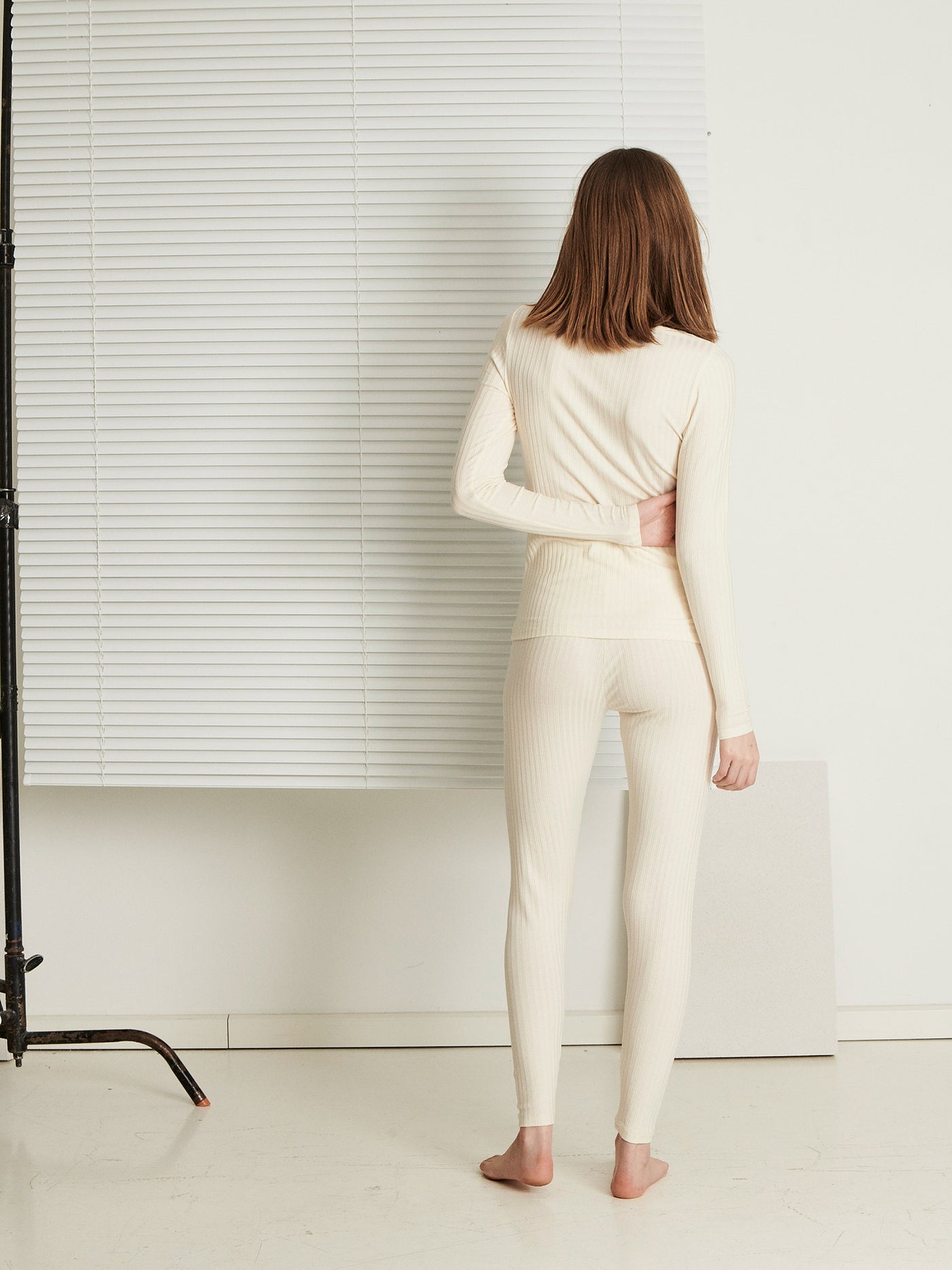 Female wearing our Celine Leggings Creme. Seen from the back.