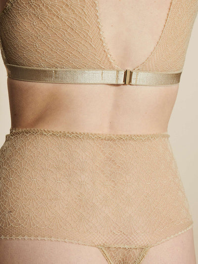 Female wearing our Christy High Apex Bra Beige. Seen from the back and in a close up. 
