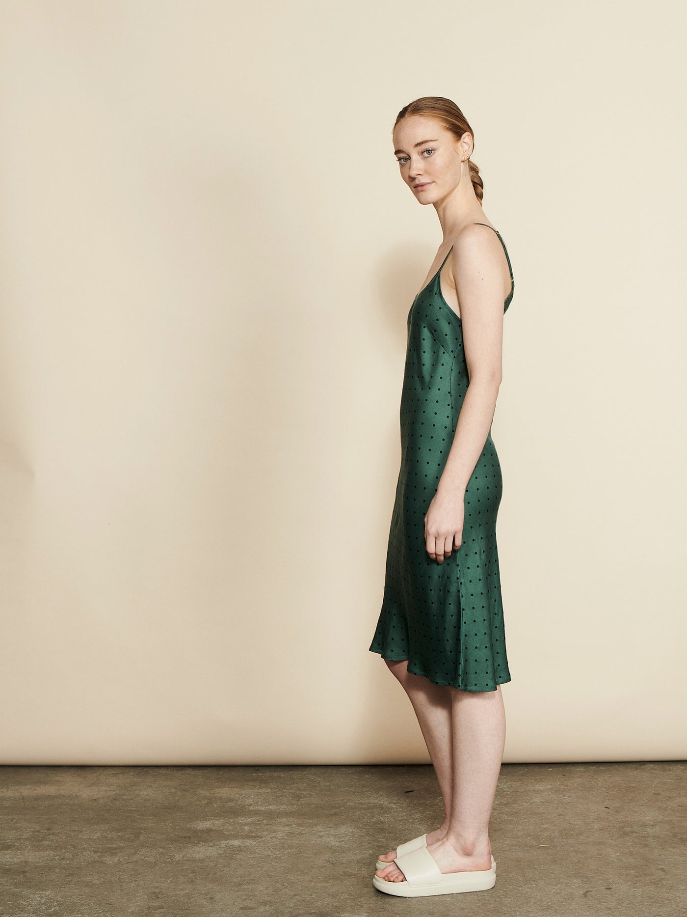 Female wearing our Fie Slip Dress Forest. Seen from the side.